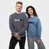 A grey unisex sweatshirt worn by a man and a blue unisex sweatshirt worn by a woman, both featuring a logo.