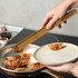 Bamboo serving tongs in a rectangular kraft paper box with a logo, featuring a natural wood finish.