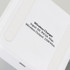 A wireless charging stand in white with a smooth surface and a branding logo on the base.