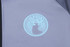 A grey sports jacket featuring a light blue circular logo on the front.