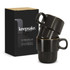 A set of two black stackable coffee cups displayed in a box, featuring a logo on the front.
