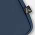 A soft-touch laptop sleeve in deep navy with a small branded tag on the edge.
