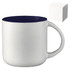 A ceramic mug with a white body and navy blue rim, presented with a plain gift box.