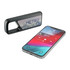 A Bluetooth speaker in black alongside a smartphone displaying a music app interface. The speaker has a logo.