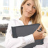 A woman holding a sleek, black leather A5 compendium with a pen, set against a bright, modern office background.