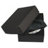A silver compact mirror inside a black box, resting on a soft black cloth. The box has a minimalist design.