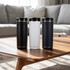 A drink bottle trio featuring black, white, and navy options, with a sleek design and a logo on each.
