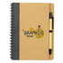 A brown spiral-bound notebook with a black cover and a black ballpoint pen attached. It features a design logo.