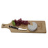 A bamboo serving board with a cheese round, grapes, and a cheese knife, featuring a logo on the surface.