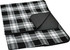 A black and white checked picnic rug with a smooth backing, featuring an integrated fold for easy storage.