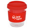 A reusable coffee cup with a transparent body, red silicone lid, and a red silicone band. It features a logo.