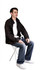 A compact folding chair in white with a person seated, wearing casual attire and a black jacket.