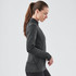 A women's black thermal 1/4 zip jumper, featuring a fitted design and long sleeves, with a logo on the hem.