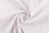 A white beach towel fabric displayed in a swirling pattern, showcasing its soft texture. It features a logo.