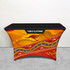 A table cloth featuring vibrant designs in orange, red, and blue, with abstract patterns and a logo at the top.
