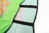 A green mesh staff bib featuring black straps and a logo on the front.
