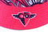 A reversible bucket hat in vibrant pink with a patterned brim and a logo on the side.
