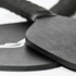 A black pickleball paddle and ball set with a textured grip, featuring a logo on one item.