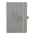 A grey hard-bound journal with an embossed design and an elastic closure. It includes a logo on the cover.