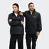 A unisex black windbreaker jacket displayed on two models, featuring pockets and a logo.