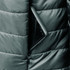 A puffer jacket with a zippered pocket, containing a smartphone, in a dark colour.