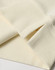 A close-up of a cream-coloured unisex crew neck sweater, featuring ribbed cuffs and hem. It has a logo.