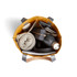 A yellow tote bag filled with a drink bottle, headphones, a blanket, a wallet, and a notebook. Includes branding.