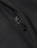A close-up of a black softshell jacket featuring a zipper detail and a textured fabric finish.