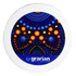 A circular ceramic coaster featuring a vibrant blue and orange design with dots, surrounded by a white border and a logo.