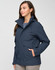 A unisex quilted waterproof jacket in navy, featuring a hood and front pockets, worn by a model.