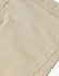 A close-up of beige chino pants, featuring a pocket and textured fabric details. The pants have a logo on them.