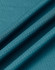 A close-up of teal jacquard knit fabric, displaying its textured surface and folds. The fabric has a subtle pattern.
