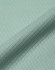 A close-up of a textured fabric in light green, showcasing a jacquard knit pattern. The image features a subtle sheen.