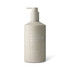 A cream bottle in a neutral beige shade with a pump dispenser, featuring a logo and "Great Barrier Reef" branding.