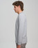 A grey long-sleeve T-shirt displayed on a model from the side, featuring a simple design and a logo.