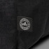 A black backpack made from recycled ocean plastic with a small logo patch.