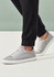 A pair of black jogger scrub pants paired with grey sneakers, featuring a cuffed hem detail.