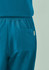 A pair of women's jogger scrub pants in teal with an elastic waistband and a side pocket.