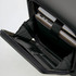 A black carry-on suitcase interior featuring compartments for a laptop and documents. It includes a logo.