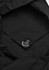A black tote bag with a simple inner tag featuring a logo, showcasing a minimalist design.