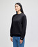 A black adult crewneck sweatshirt, featuring a logo, displayed on a model. The style is casual and sporty.