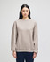 A grey Champion Powerblend® adult crewneck sweatshirt displayed on a model with long dark hair.