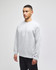 A grey crewneck sweatshirt on a model, featuring a small logo on the cuff.
