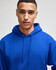A blue pullover hooded sweatshirt with a front pocket and drawstring hood, worn by a model. It features a logo.