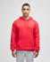 A red pullover hooded sweatshirt is worn by a model, styled with grey sweatpants. The garment has a front pocket and a logo.
