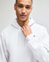 A white pullover hooded sweatshirt with a logo, worn by a person with short hair.
