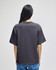 A black pullover hooded sweatshirt with a relaxed fit, featuring a small logo on the back.