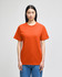 An orange short-sleeve t-shirt on a model, featuring a logo on the sleeve.
