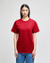 A red Champion adult short-sleeve t-shirt displayed on a model, featuring a logo on the sleeve.