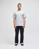 A grey short-sleeve t-shirt worn by a model, paired with dark pants. The shirt has a small logo on the sleeve.